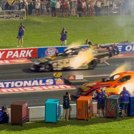 fire exploding from race cars at starting line of NHRA US Nationals.