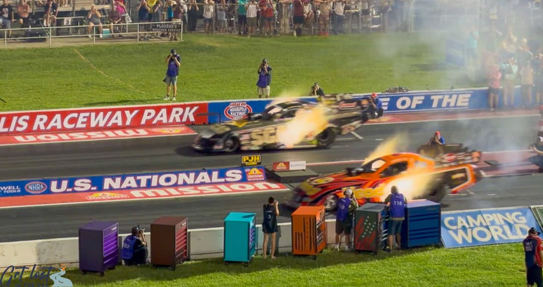 fire exploding from race cars at starting line of NHRA US Nationals.